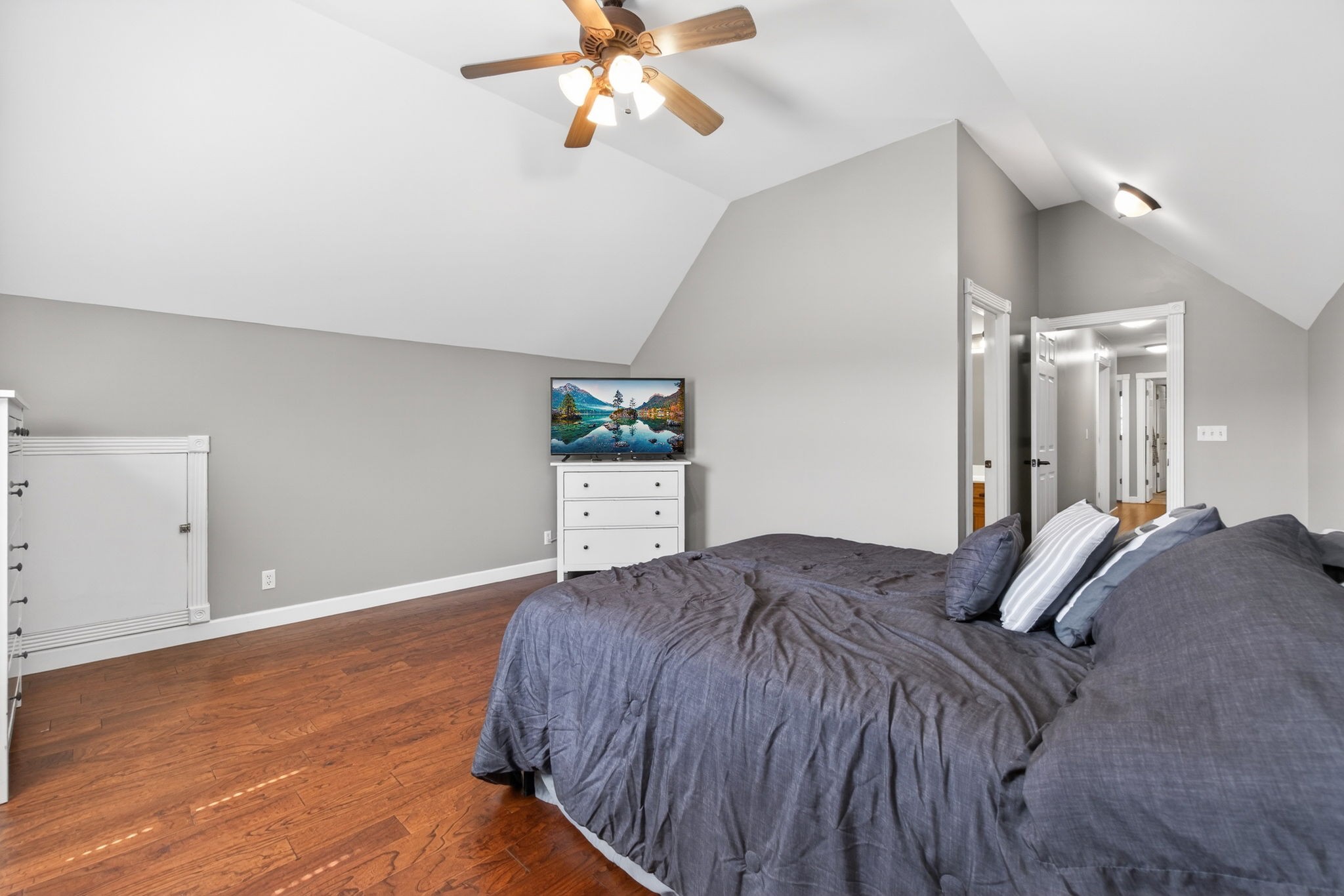 3432 WJ Robinson Road Cookeville, TN 38506 - Photo 19 of 32 a bedroom with a bed and a chandelier