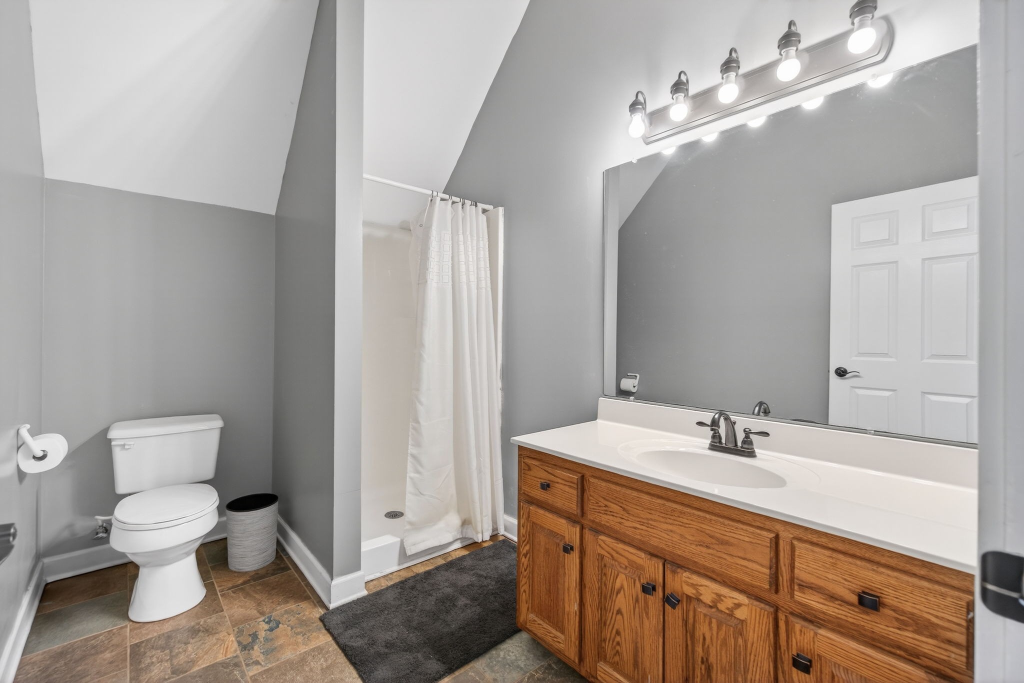 3432 WJ Robinson Road Cookeville, TN 38506 - Photo 20 of 32 a bathroom with a toilet sink and mirror