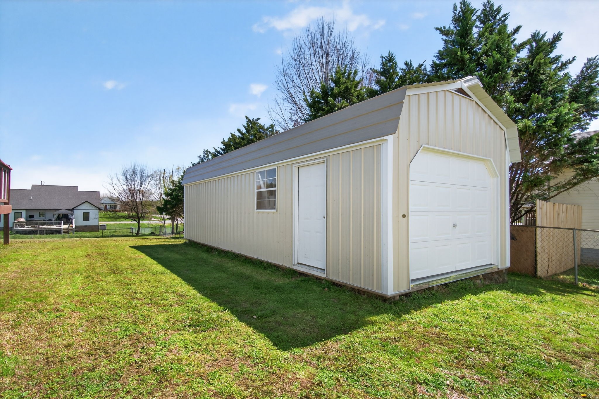 3432 WJ Robinson Road Cookeville, TN 38506 - Photo 25 of 32 a backyard of a house with plants and large trees