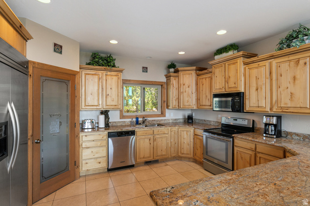 755 South Zion Ridge Drive Orderville, UT 84758 - Photo 43 of 84 Kitchen with stainless steel appliances, light tile patterned flooring, light wood finish cabinets, recessed lighting, and light stone counters