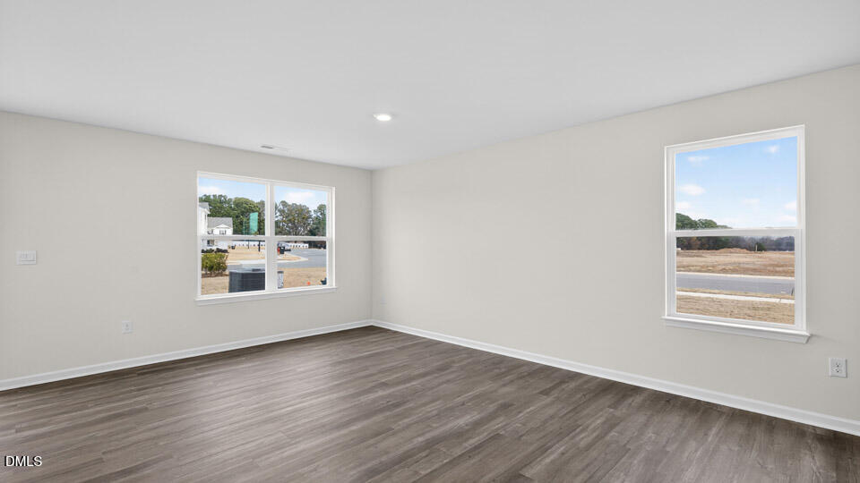16 Red Clover Drive Angier, NC 27501 - Photo 14 of 36 a view of an empty room with wooden floor and a window