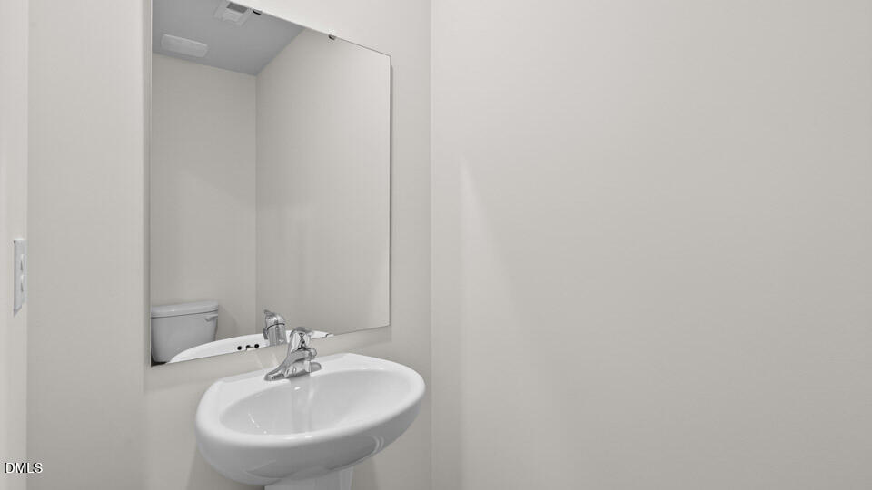 16 Red Clover Drive Angier, NC 27501 - Photo 16 of 36 a bathroom with a sink and a mirror