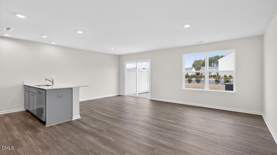 16 Red Clover Drive Angier, NC 27501 - Photo 6 of 36 a view of an empty room with wooden floor and a window