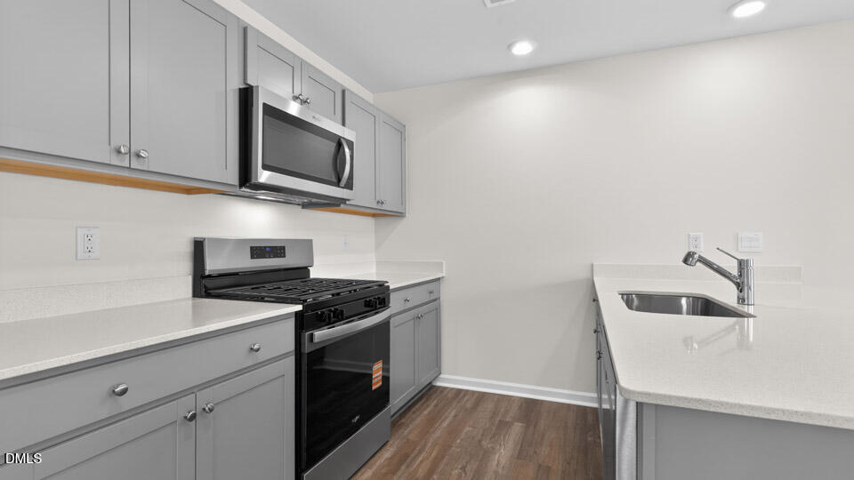 16 Red Clover Drive Angier, NC 27501 - Photo 9 of 36 a kitchen with stainless steel appliances granite countertop a sink and a stove