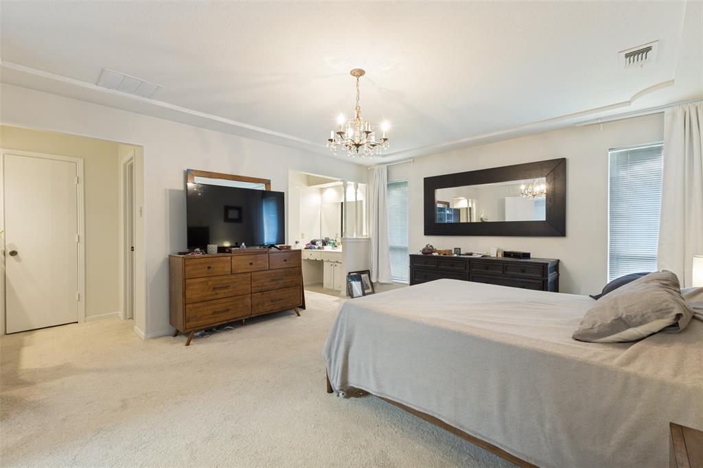 705 South Grove Road Richardson, TX 75081 - Photo 20 of 26 Spacious bedroom featuring light-toned carpet flooring and neutral wall tones
