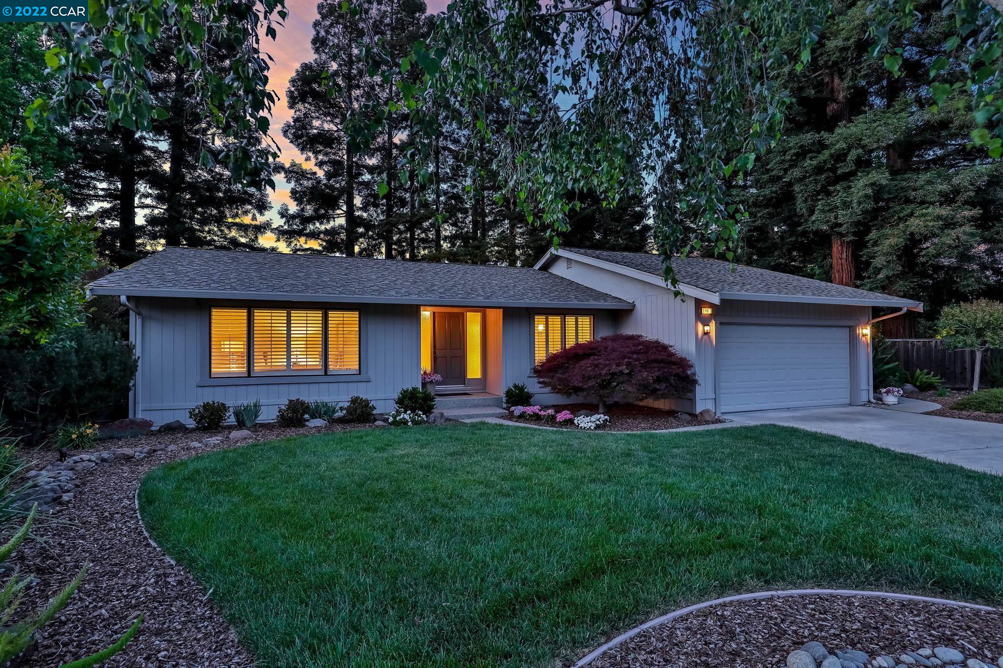 a view of a house with a backyard