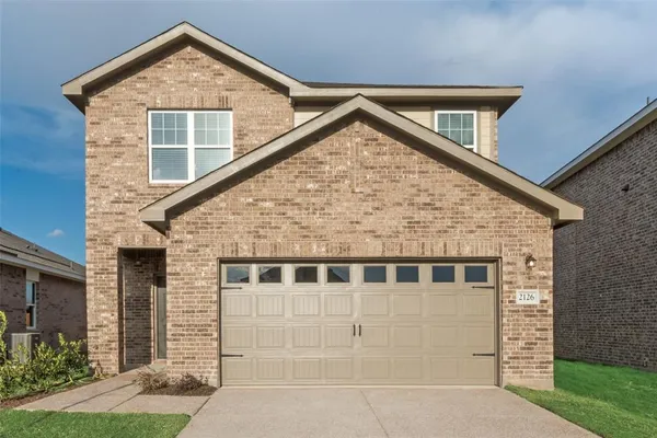 a front view of a house with garage
