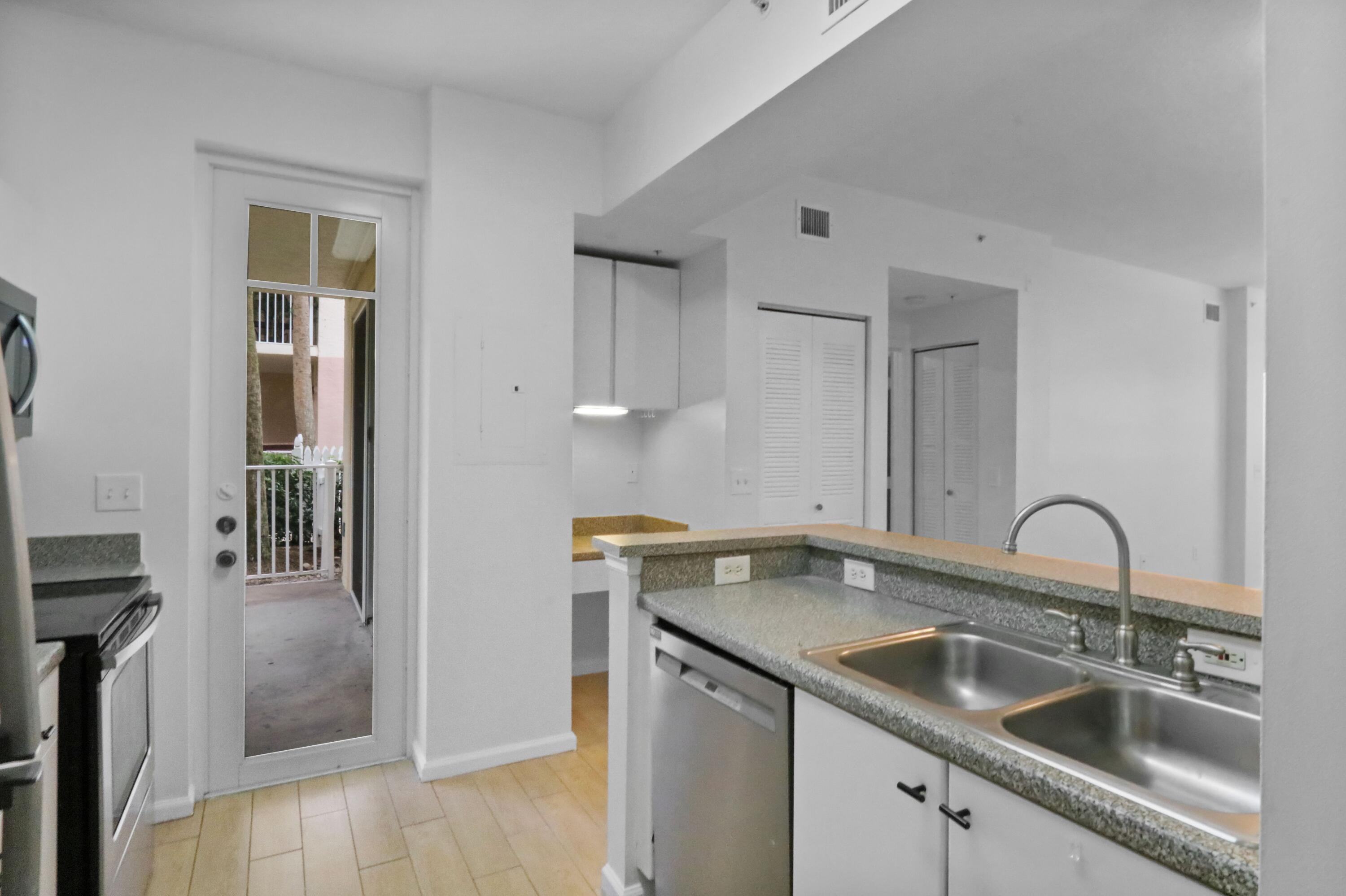 4784 Central Boulevard, Unit 10 Jupiter, FL 33458 - Photo 12 of 29 a kitchen with a sink and cabinets