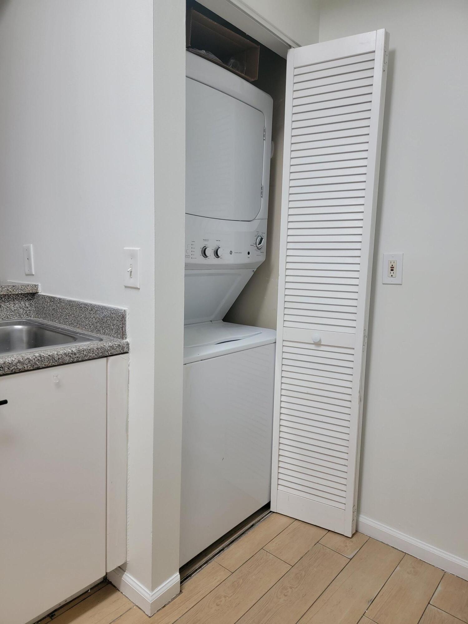 4784 Central Boulevard, Unit 10 Jupiter, FL 33458 - Photo 14 of 29 a utility room with cabinets washer and dryer