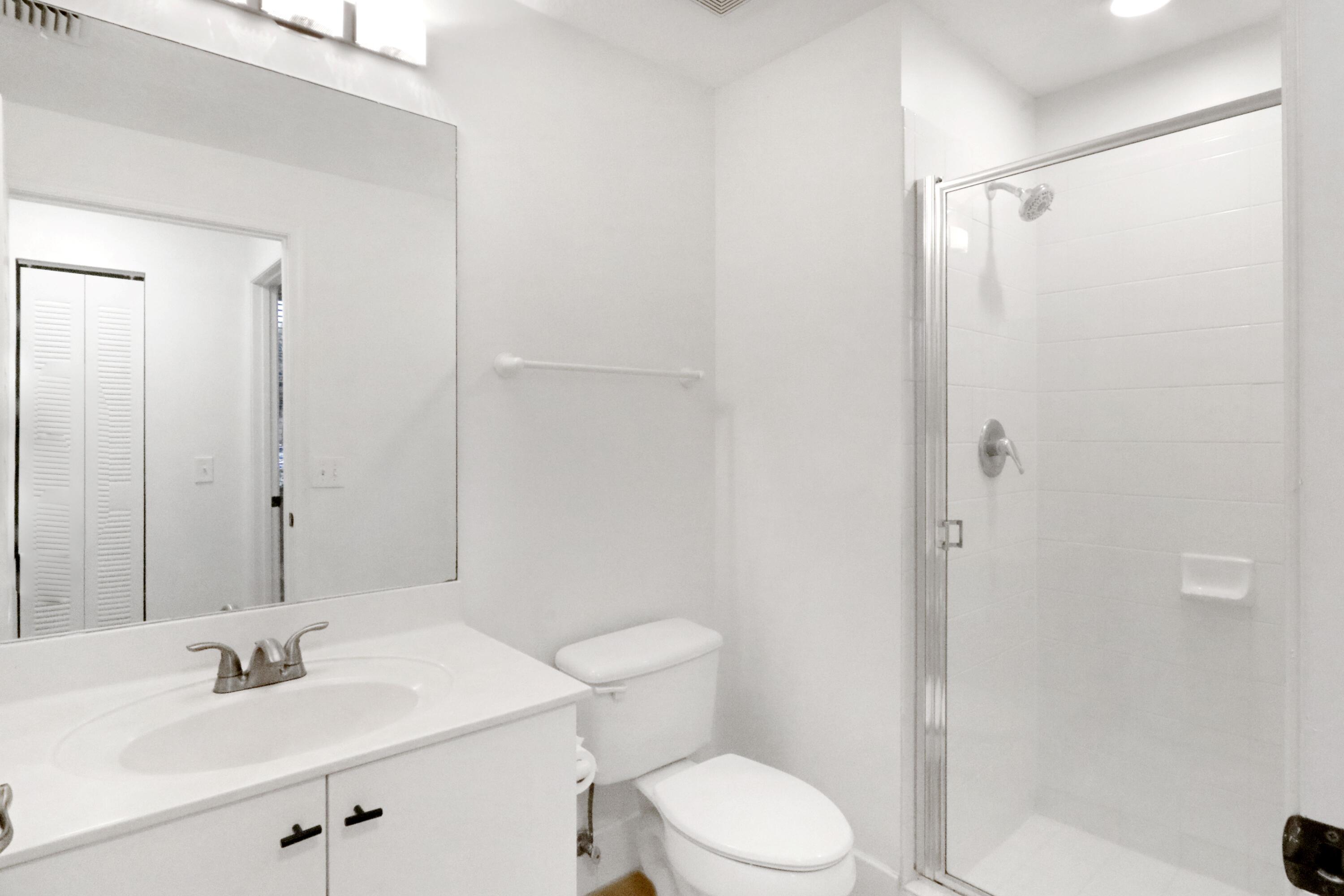 4784 Central Boulevard, Unit 10 Jupiter, FL 33458 - Photo 15 of 29 a bathroom with a sink a toilet and shower