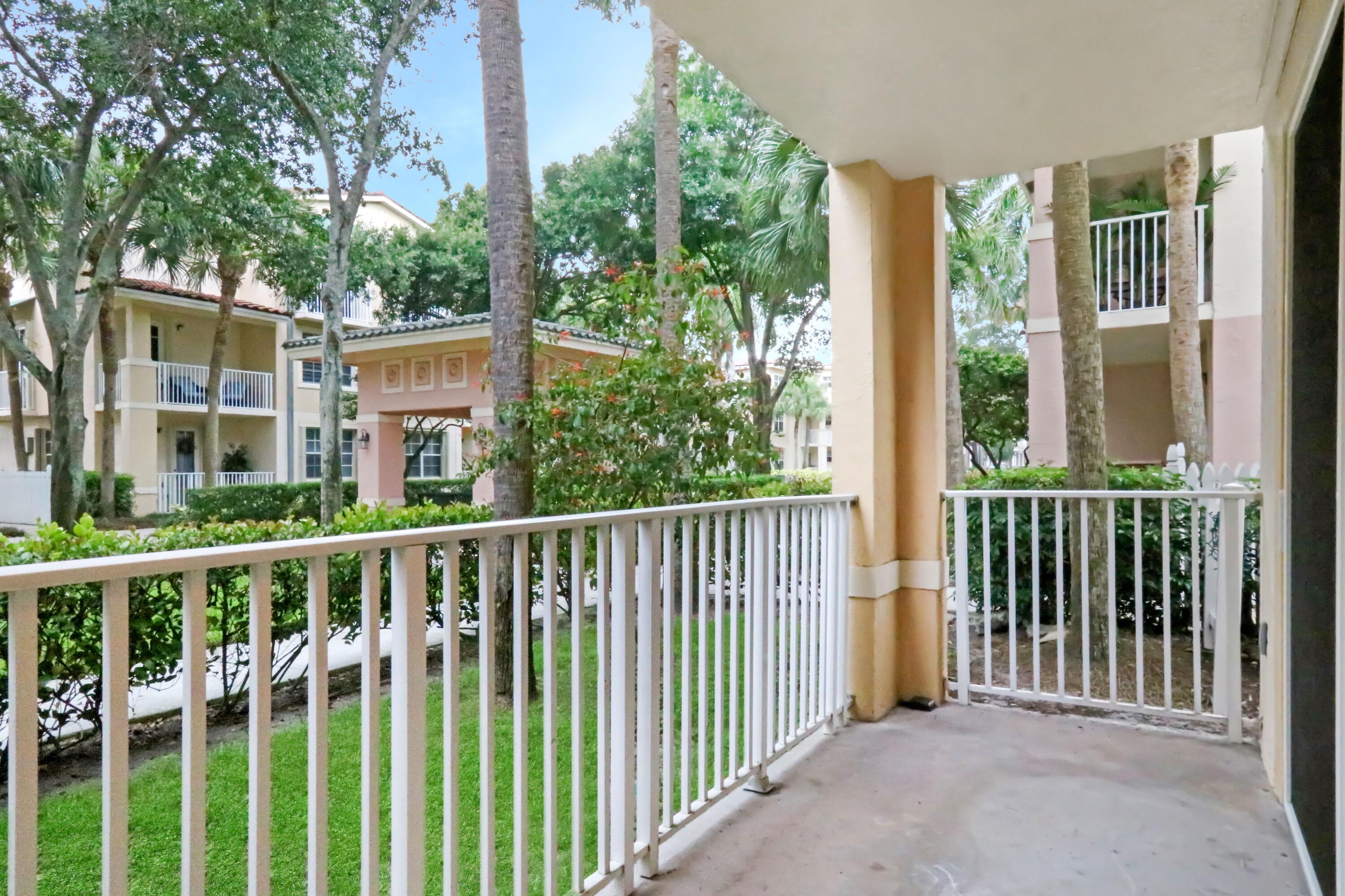4784 Central Boulevard, Unit 10 Jupiter, FL 33458 - Photo 25 of 29 a view of a house with large windows and wooden fence