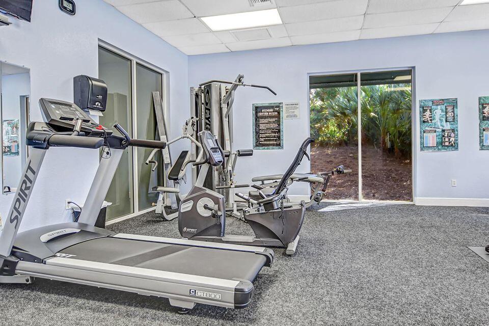4784 Central Boulevard, Unit 10 Jupiter, FL 33458 - Photo 26 of 29 a room with gym equipment and a large window