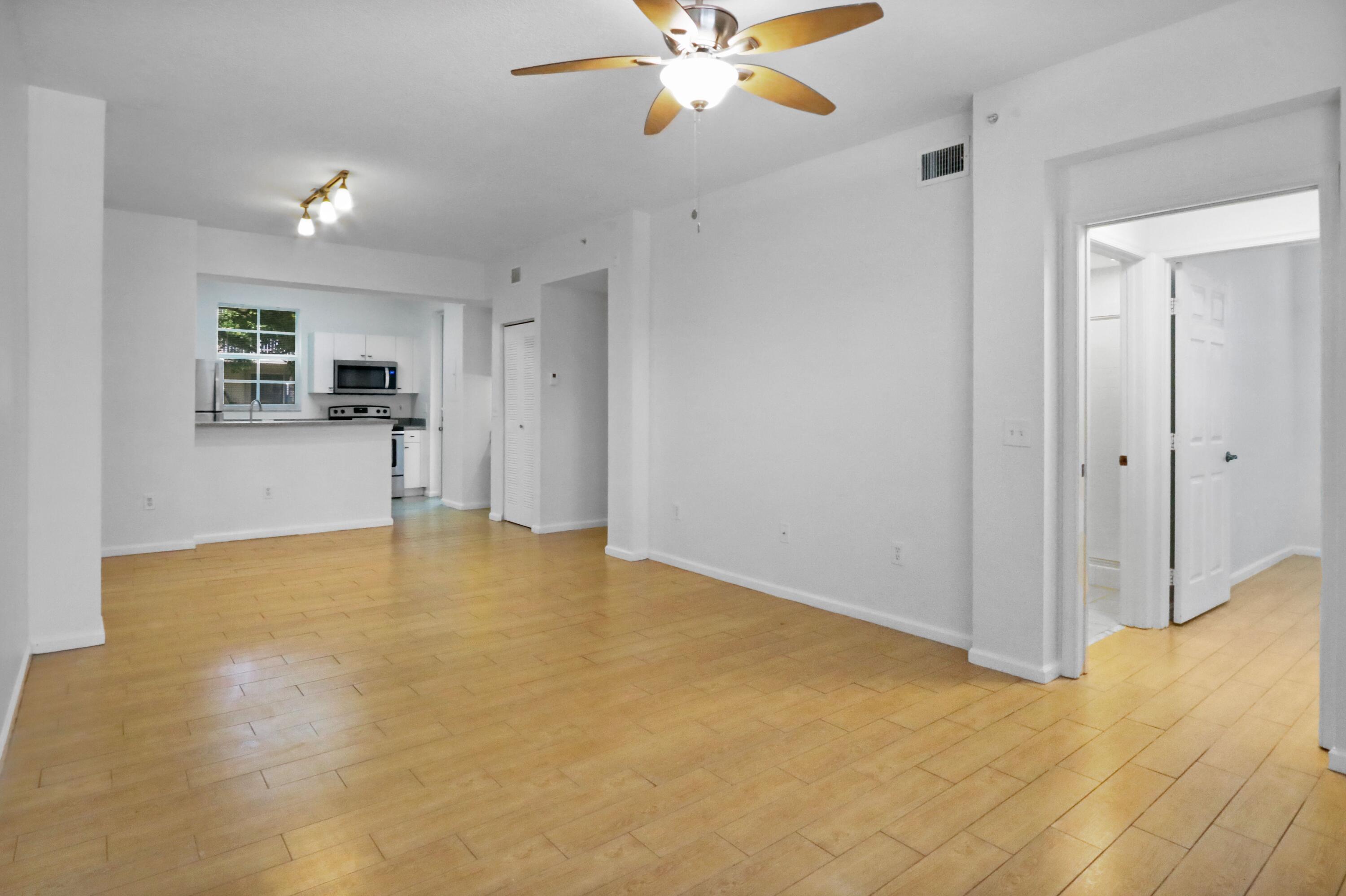 4784 Central Boulevard, Unit 10 Jupiter, FL 33458 - Photo 3 of 29 a view of an empty room with a chandelier fan