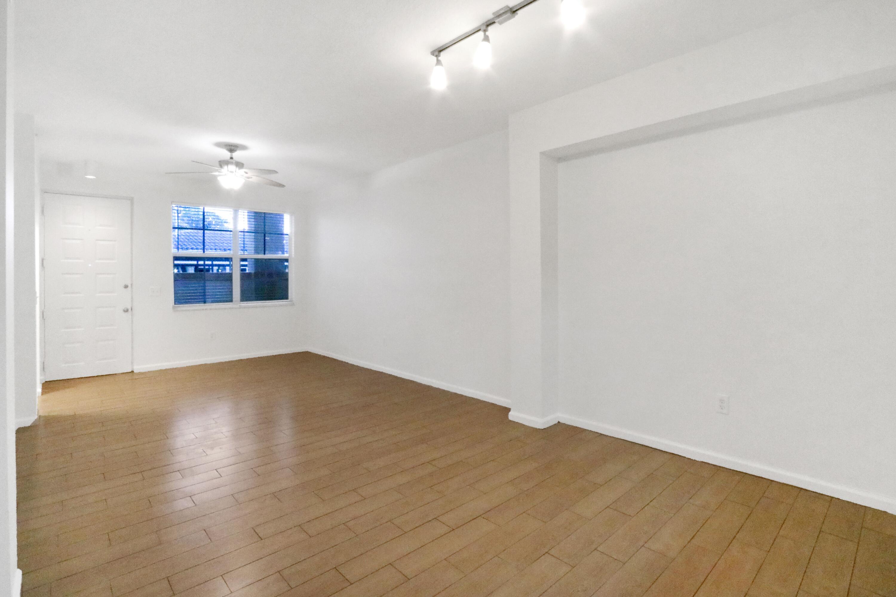 4784 Central Boulevard, Unit 10 Jupiter, FL 33458 - Photo 6 of 29 wooden floor in an empty room with a window
