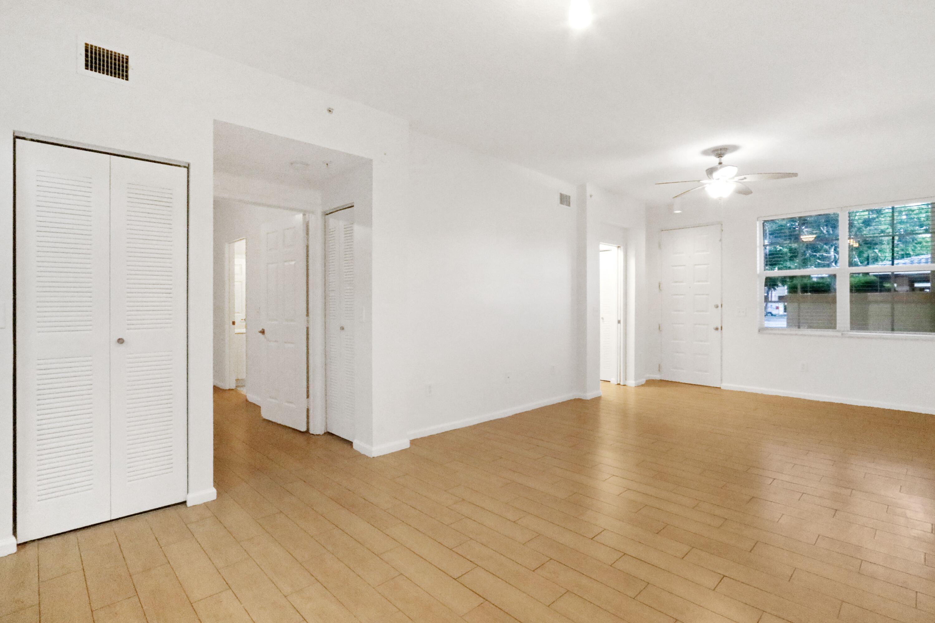 4784 Central Boulevard, Unit 10 Jupiter, FL 33458 - Photo 7 of 29 an empty room with wooden floor and windows