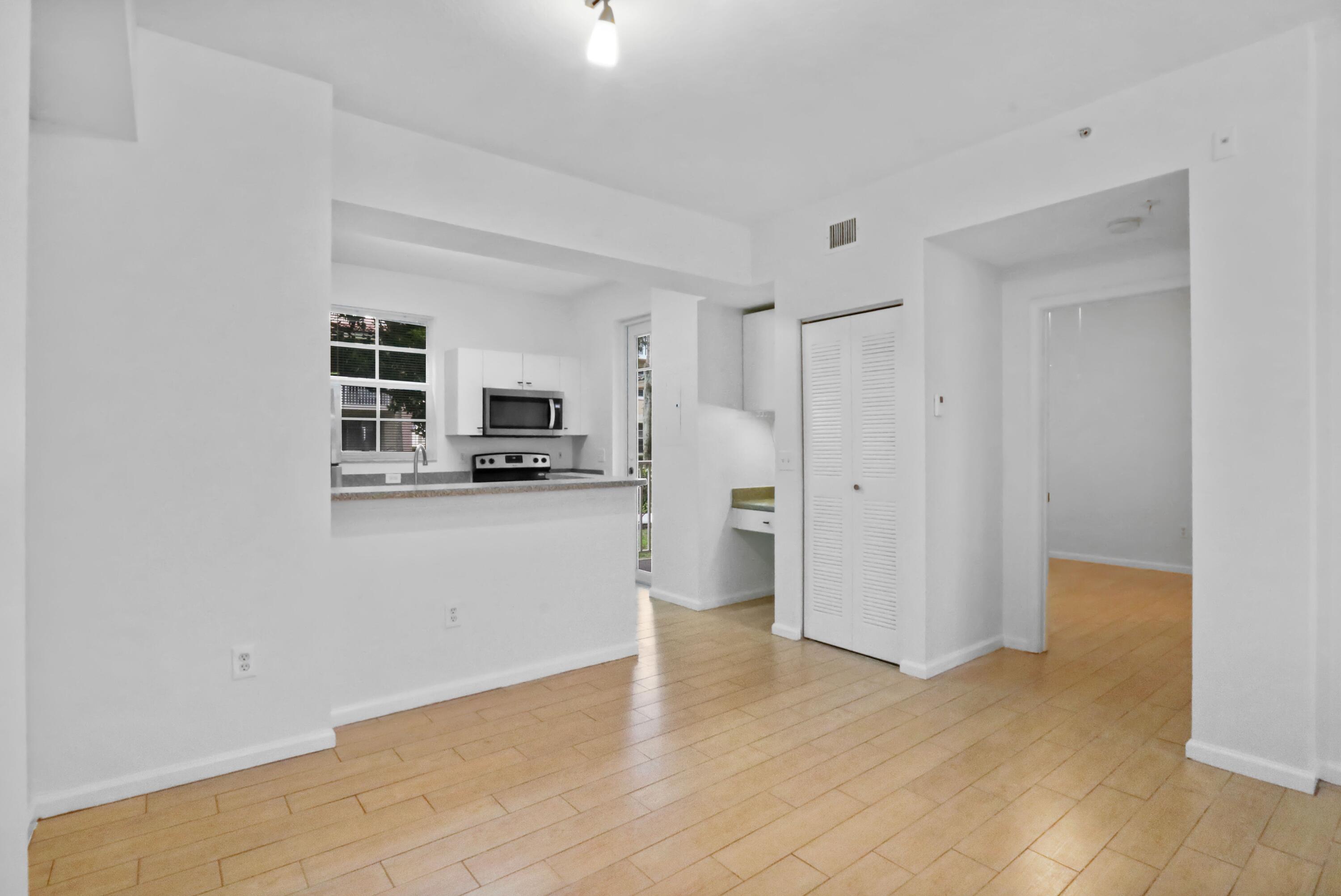 4784 Central Boulevard, Unit 10 Jupiter, FL 33458 - Photo 8 of 29 a view of a kitchen with a sink and a refrigerator
