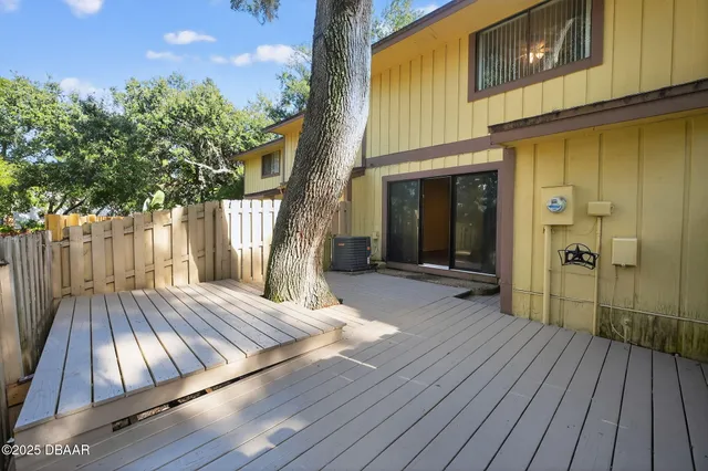 a view of backyard with a deck