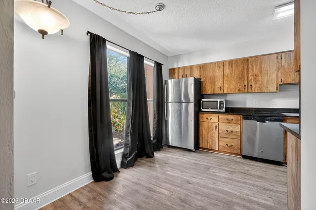 a view of a kitchen with an entryway and a window