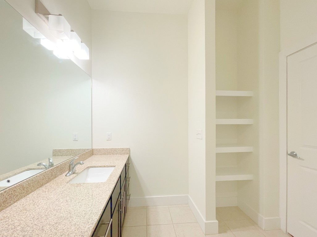 2400 Louis Henna Boulevard, Unit 103 Round Rock, TX 78664 - Photo 15 of 22 a bathroom with a sink and a mirror