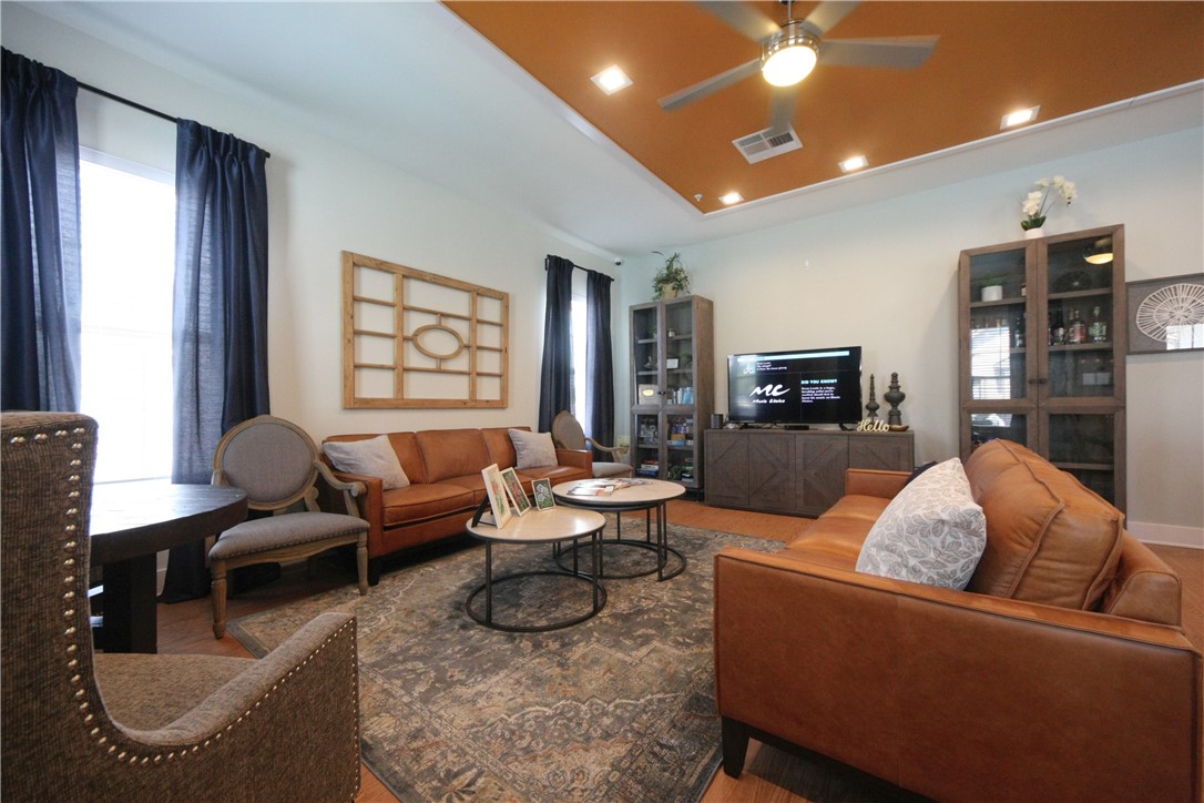 2400 Louis Henna Boulevard, Unit 103 Round Rock, TX 78664 - Photo 19 of 22 a living room with furniture fireplace and a large window