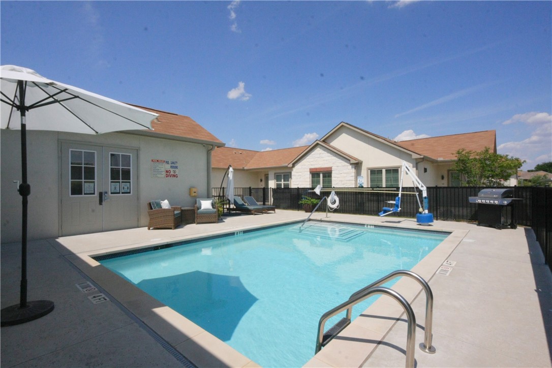 2400 Louis Henna Boulevard, Unit 103 Round Rock, TX 78664 - Photo 21 of 22 a view of swimming pool with outdoor seating and house in the background