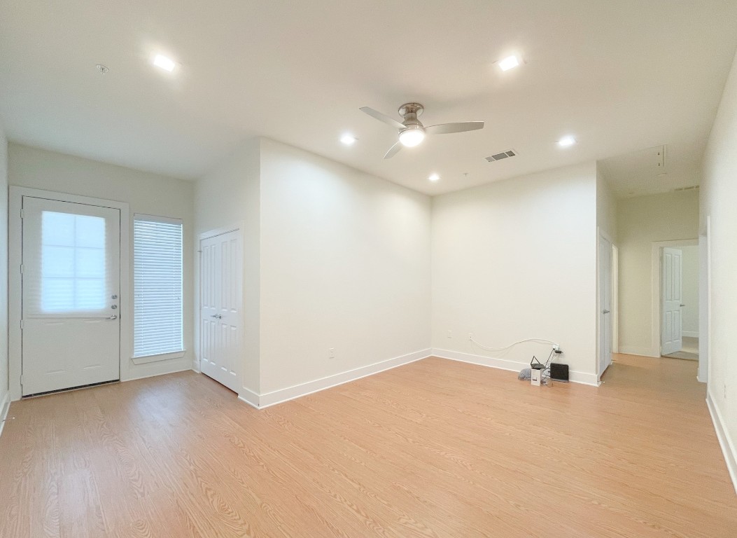 2400 Louis Henna Boulevard, Unit 103 Round Rock, TX 78664 - Photo 3 of 22 an empty room with a white cabinet and a ceiling fan