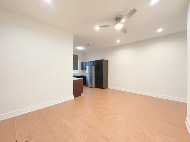 a view of kitchen with refrigerator and a stove