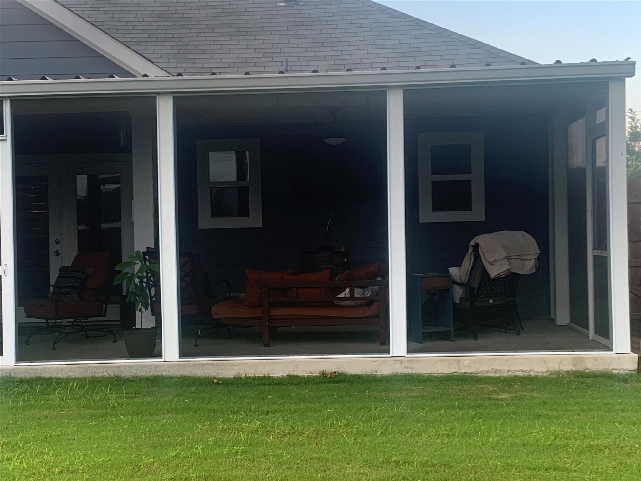 307 West Front Street Thorndale, TX 76577 - Photo 8 of 27 Back of property with a sunroom and a lawn