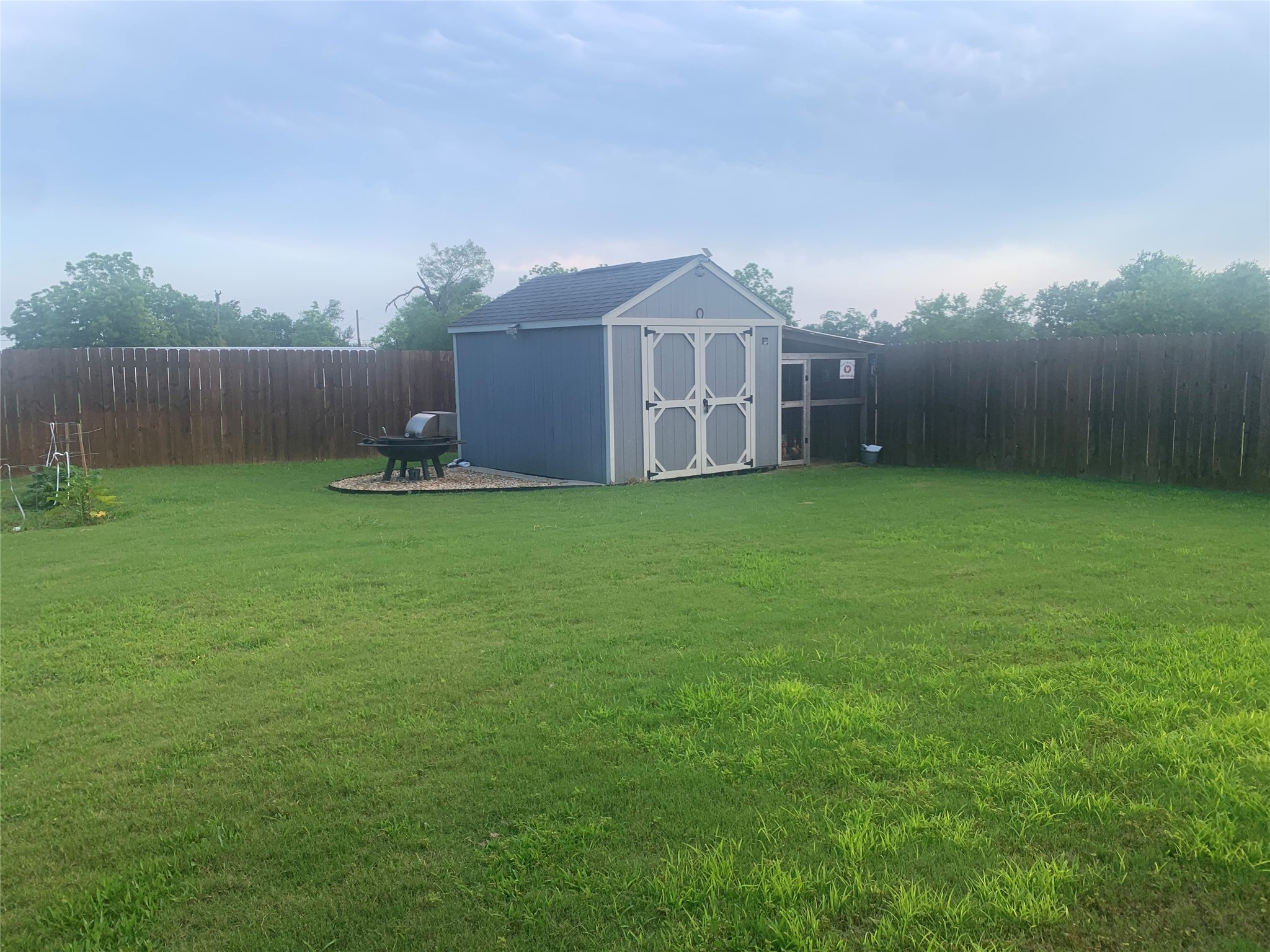 307 West Front Street Thorndale, TX 76577 - Photo 9 of 27 Fenced backyard featuring a storage shed