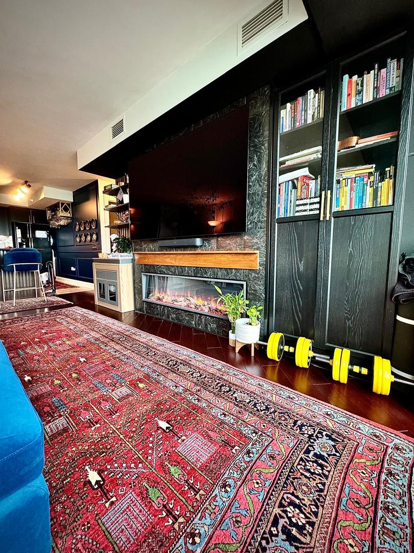 1720 Maple Avenue, Unit 2680 Evanston, IL 60201 - Photo 15 of 74 a living room with furniture a flat screen tv and a fireplace