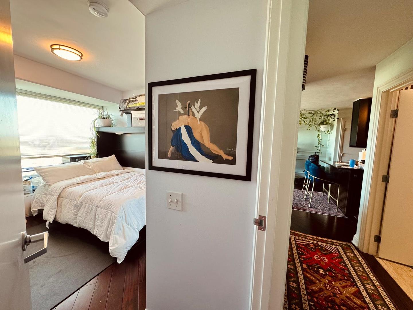 1720 Maple Avenue, Unit 2680 Evanston, IL 60201 - Photo 33 of 74 a bedroom with a bed and a painting on the wall