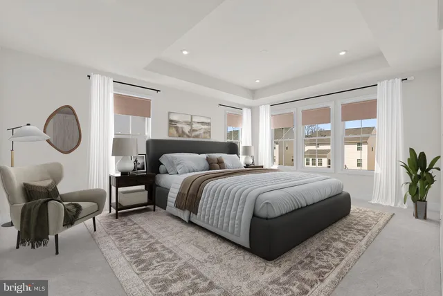 a bedroom with bed and a large window