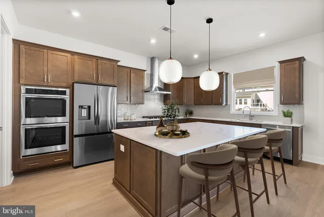 a kitchen with a table chairs refrigerator and microwave