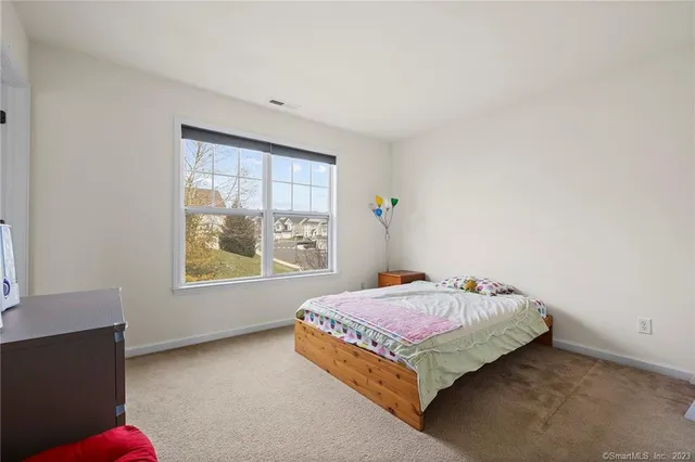 a bedroom with a bed and window