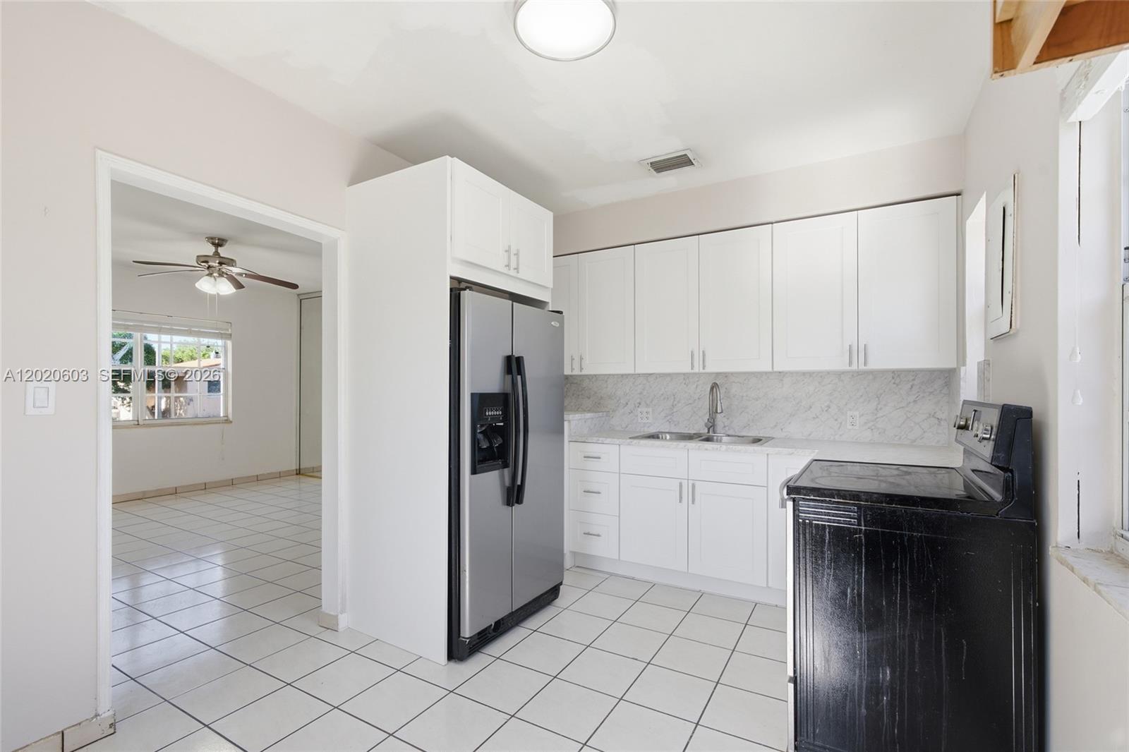 3750 Southwest 27th Street Miami, FL 33134 - Photo 20 of 41 a kitchen with a sink cabinets and appliances