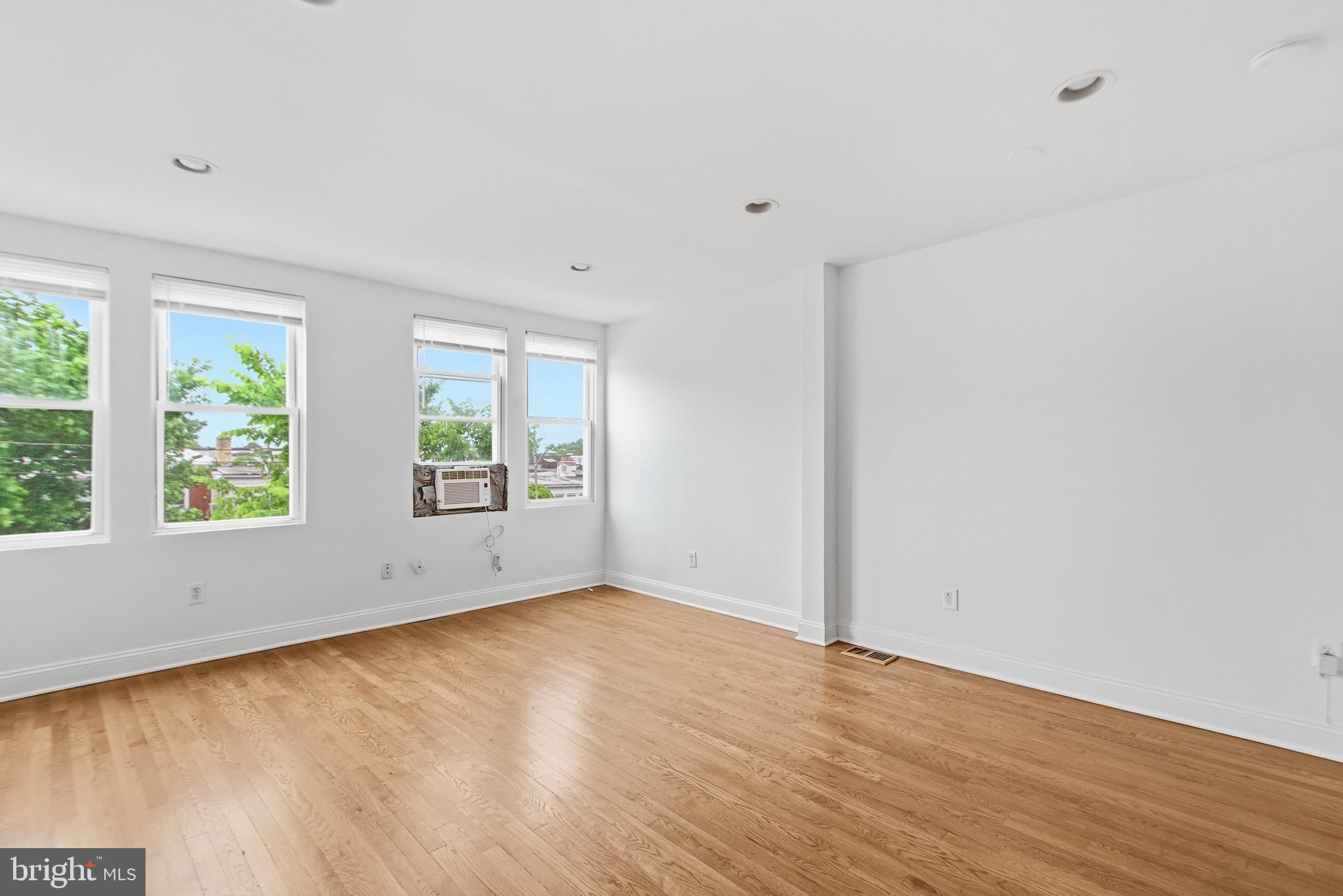 440 Delafield Place Northwest Washington, DC 20011 - Photo 19 of 33 an empty room with wooden floor and windows