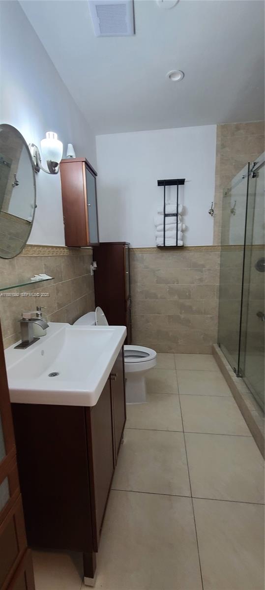 1721 Southwest 24th Terrace Miami, FL 33145 - Photo 36 of 80 a bathroom with a sink a toilet and mirror