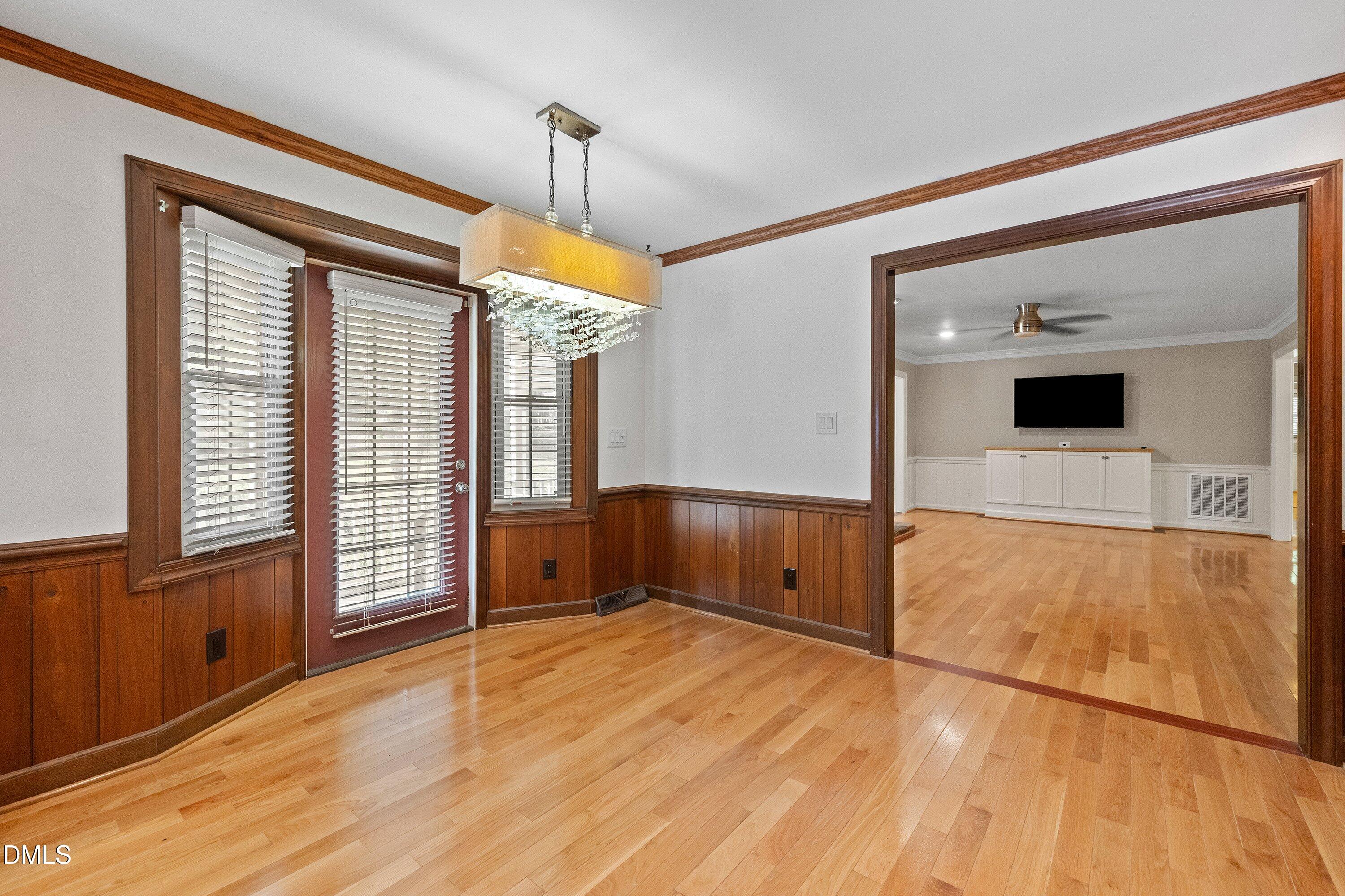 8133 Holly Forest Road Wake Forest, NC 27587 - Photo 18 of 50 a view of empty room with wooden floor and fan