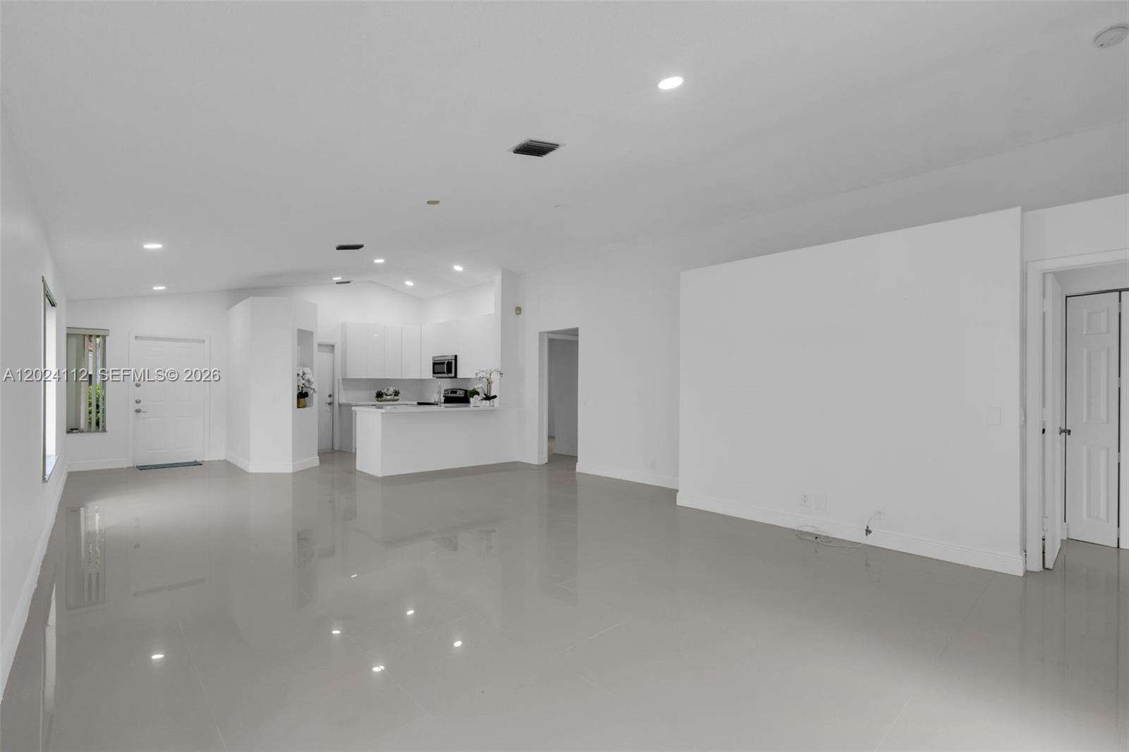 4366 Mahogany Ridge Drive Weston, FL 33331 - Photo 10 of 41 a view of a big room with kitchen island wooden cabinets and refrigerator