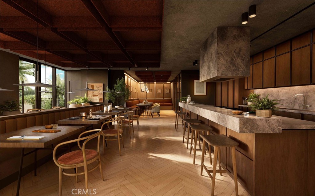 9 Mac Arthur Place, Unit 508 Santa Ana, CA 92707 - Photo 11 of 15 a kitchen with table chairs stove and flat screen tv