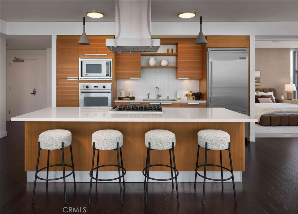 9 Mac Arthur Place, Unit 508 Santa Ana, CA 92707 - Photo 3 of 15 a kitchen with stainless steel appliances granite countertop a table chairs sink and cabinets