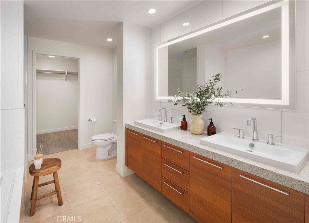 9 Mac Arthur Place, Unit 508 Santa Ana, CA 92707 - Photo 7 of 15 a spacious bathroom with a double vanity sink mirror and toilet