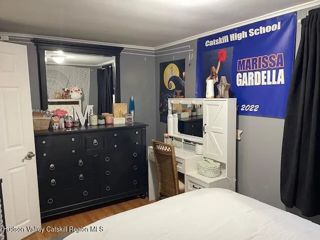 a bedroom with a bed and a dresser in it