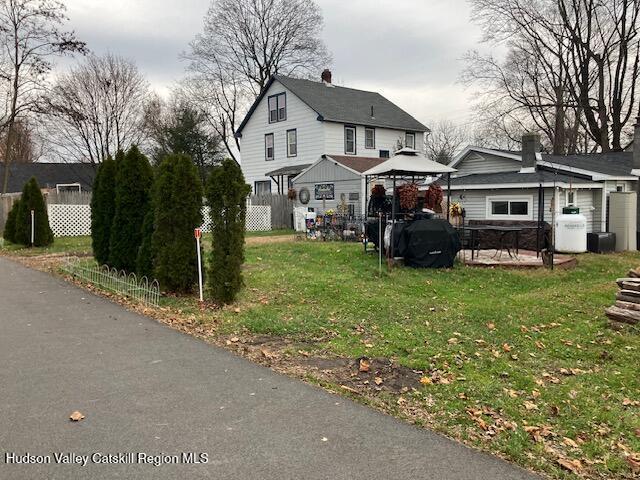 170 Broome Street Catskill, NY 12414 - Photo 18 of 18 a front view of a house with a garden and trees