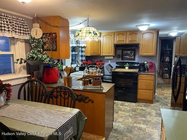 a kitchen view of a dining table chairs and fire place