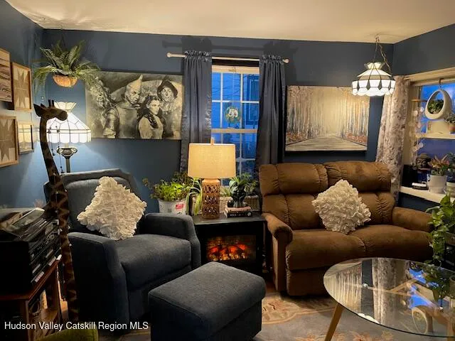 a living room with furniture and painting on the wall