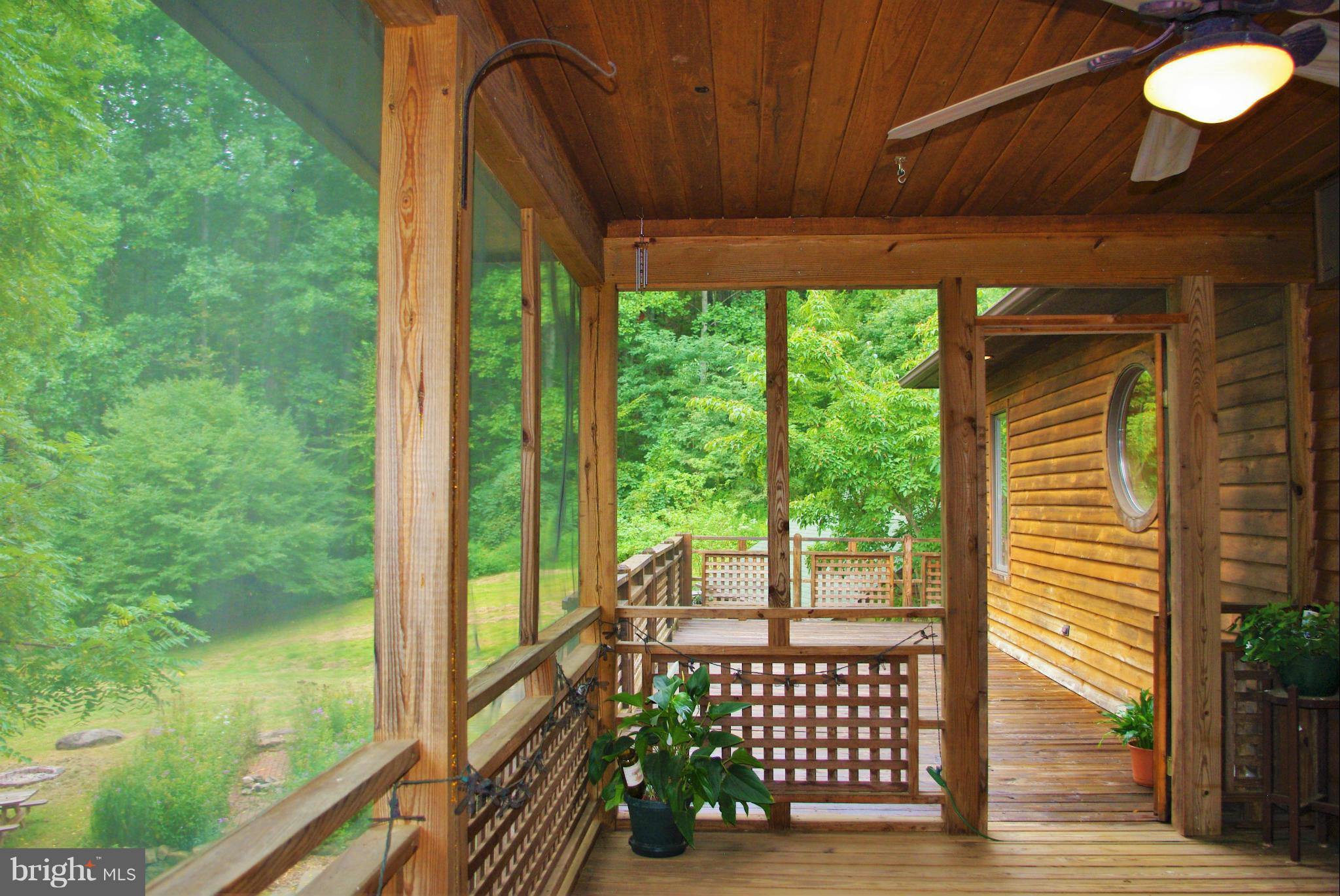 416 Rolling Road Sperryville, VA 22740 - Photo 12 of 25 Screened porch with the deck beyond