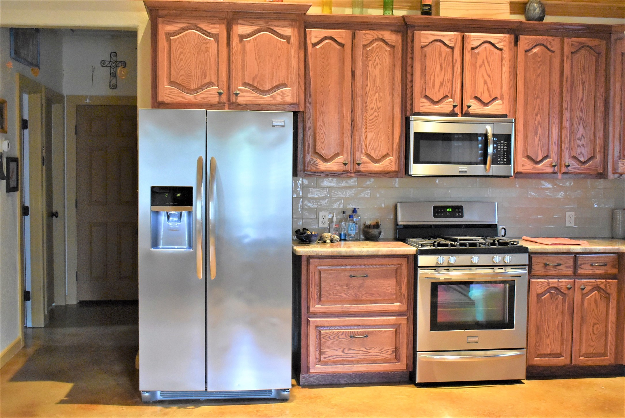 412 Pecan Street Sweeny, TX 77480 - Photo 11 of 32 a kitchen with stainless steel appliances granite countertop a refrigerator and a stove top oven