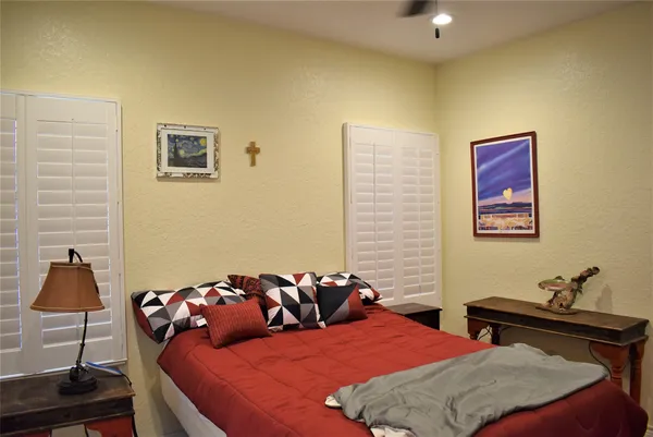 a bedroom with a bed and a lamp