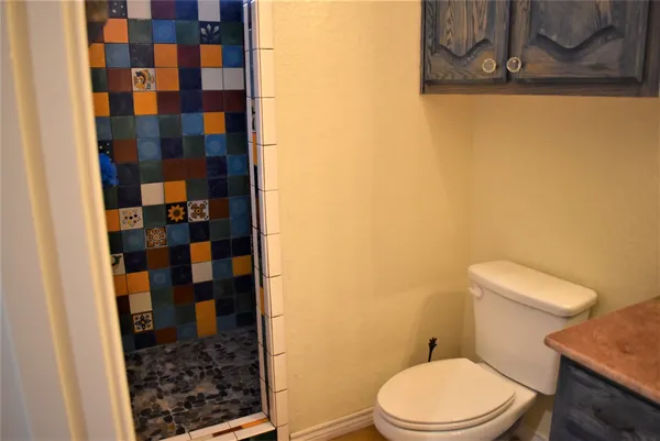 a white toilet sitting next to a bathroom sink